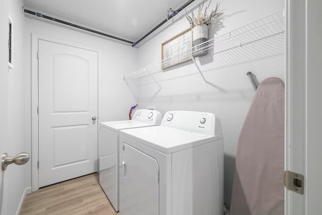 302 W College St, Branson, MO 65616 - laundry room with washing machine and dryer and light wood-type flooring