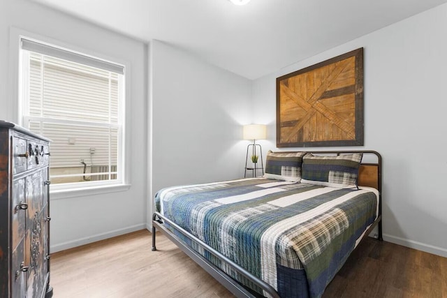 302 W College St, Branson, MO 65616 - bedroom featuring light wood-type flooring and baseboards