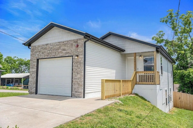 302 W College St, Branson, MO 65616 - view of front of home featuring a garage, driveway, and stone siding