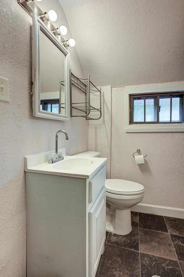 1027 S Orner St, Carthage, MO 64836 - bathroom featuring vanity, a textured wall, and lofted ceiling