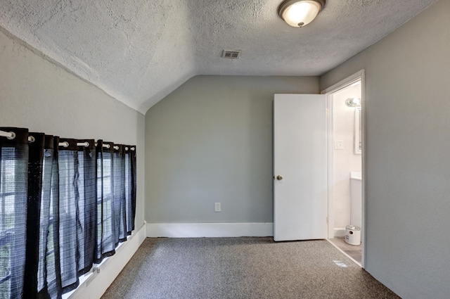 1027 S Orner St, Carthage, MO 64836 - carpeted spare room featuring a textured ceiling and vaulted ceiling