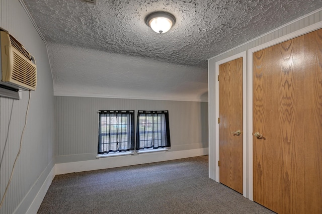 1027 S Orner St, Carthage, MO 64836 - unfurnished bedroom with carpet flooring, ornamental molding, a wall unit AC, and a textured ceiling