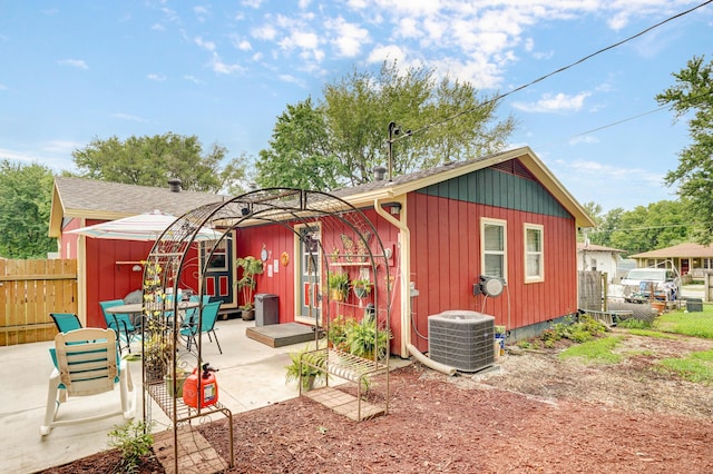 1648 N Yates Ave, Springfield, MO 65803 - back of property with a patio area and board and batten siding