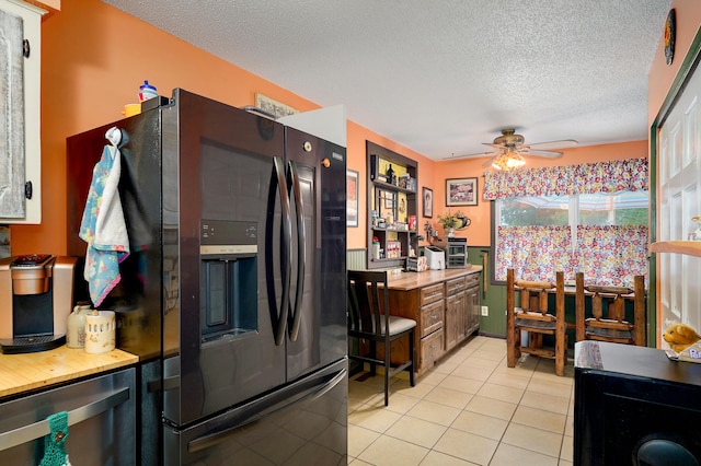 1648 N Yates Ave, Springfield, MO 65803 - kitchen with black fridge with ice dispenser, light tile patterned flooring, a ceiling fan, a textured ceiling, and stainless steel dishwasher