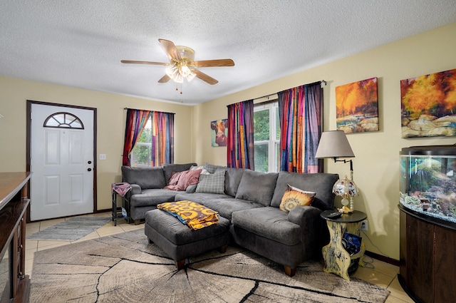 1648 N Yates Ave, Springfield, MO 65803 - living area with light tile patterned floors, healthy amount of natural light, ceiling fan, and a textured ceiling