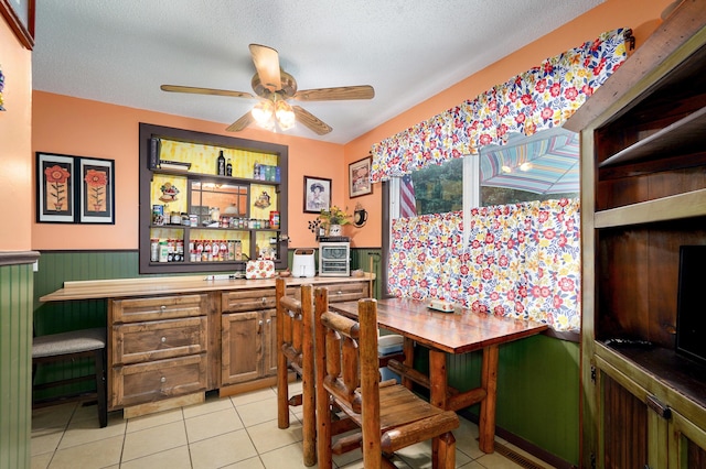 1648 N Yates Ave, Springfield, MO 65803 - dining area with a bar, a ceiling fan, wainscoting, and light tile patterned floors