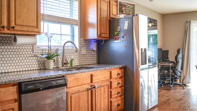 921 Woodhurst Dr, Marshfield, MO 65706 - kitchen with dishwashing machine, stainless steel fridge, wood finished floors, decorative backsplash, and brown cabinets