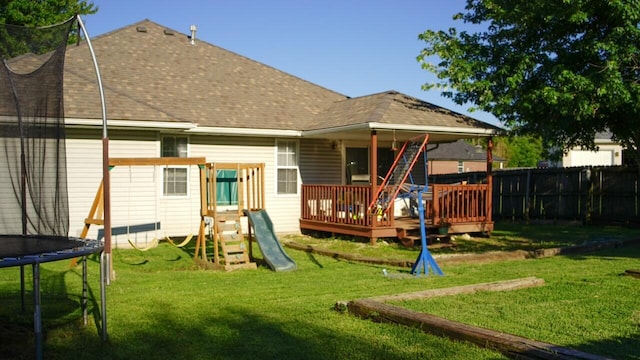 921 Woodhurst Dr, Marshfield, MO 65706 - rear view of house with a trampoline, roof with shingles, a deck, and a playground