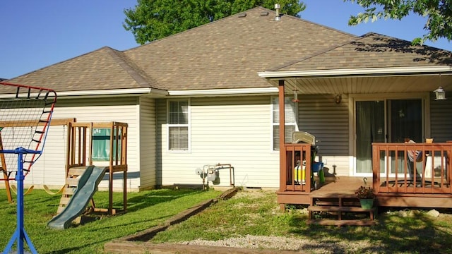 921 Woodhurst Dr, Marshfield, MO 65706 - rear view of house featuring a playground, roof with shingles, a lawn, and a deck
