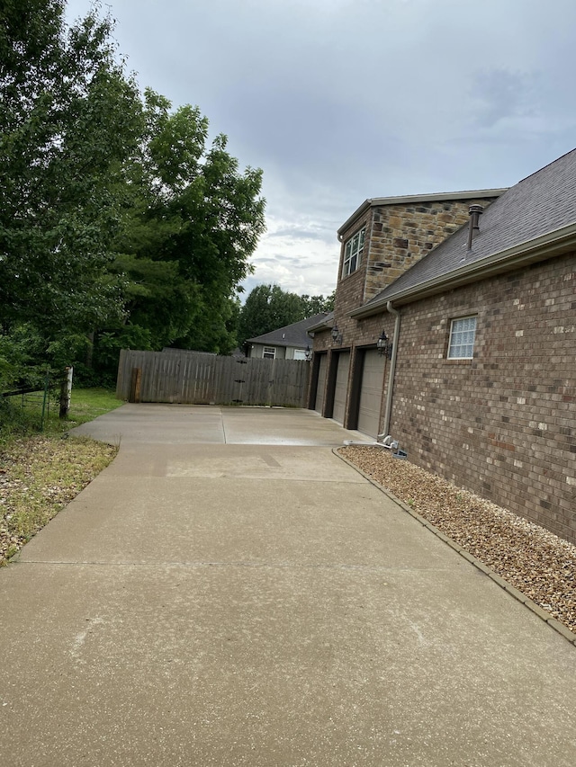 2114 E Finch St, Ozark, MO 65721 - view of patio / terrace featuring concrete driveway and an attached garage