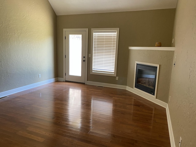 2114 E Finch St, Ozark, MO 65721 - unfurnished living room featuring a textured wall, wood finished floors, and a glass covered fireplace