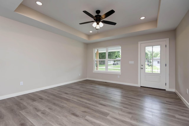 1851 N Patterson Ave, Springfield, MO 65803 - unfurnished room featuring a raised ceiling, healthy amount of natural light, wood finished floors, and recessed lighting