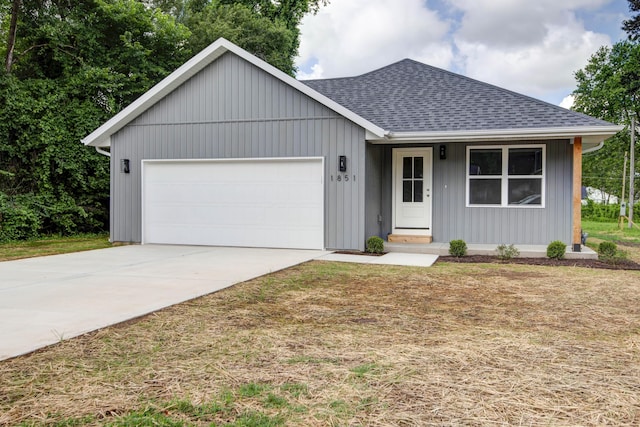 1851 N Patterson Ave, Springfield, MO 65803 - ranch-style home featuring an attached garage, a shingled roof, and driveway