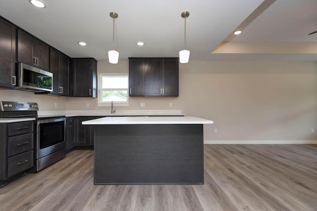 1851 N Patterson Ave, Springfield, MO 65803 - kitchen with stainless steel appliances, light countertops, a center island, light wood-style flooring, and recessed lighting