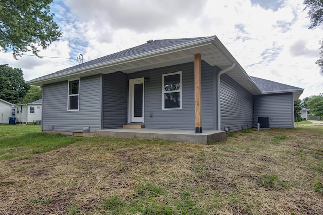 1851 N Patterson Ave, Springfield, MO 65803 - back of property featuring covered porch, a yard, and roof with shingles