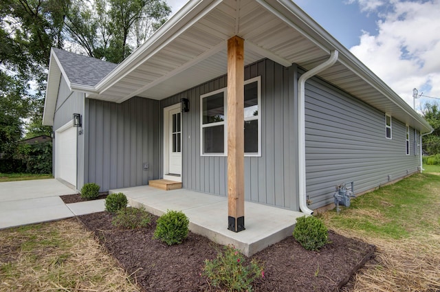 1851 N Patterson Ave, Springfield, MO 65803 - view of front of house with an attached garage, board and batten siding, roof with shingles, and driveway