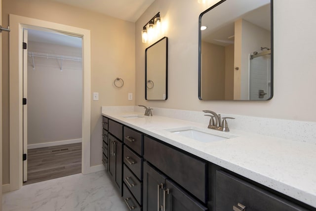 1851 N Patterson Ave, Springfield, MO 65803 - full bathroom featuring double vanity, marble finish flooring, and a spacious closet