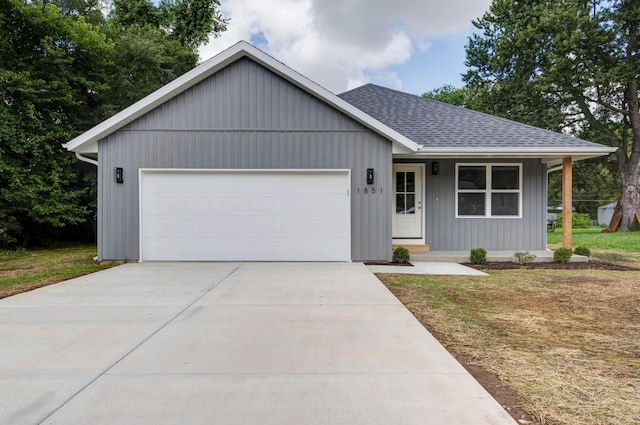 1851 N Patterson Ave, Springfield, MO 65803 - ranch-style home with roof with shingles, an attached garage, concrete driveway, a porch, and a front yard