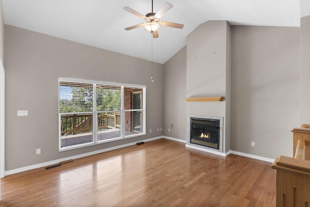 169 Tanner Rd, Branson, MO 65616 - unfurnished living room with a ceiling fan, wood finished floors, a warm lit fireplace, and high vaulted ceiling