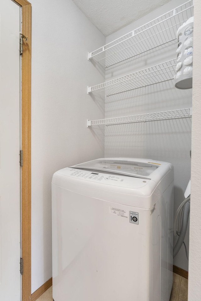 421 W White Ash Rd, Nixa, MO 65714 - laundry room with washer / dryer and baseboards