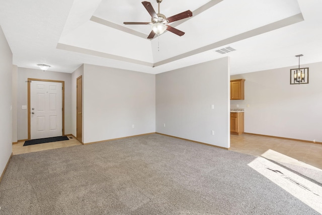 421 W White Ash Rd, Nixa, MO 65714 - unfurnished room featuring light carpet, a ceiling fan, a tray ceiling, and a chandelier