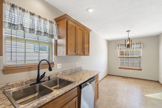 421 W White Ash Rd, Nixa, MO 65714 - kitchen with dishwasher, brown cabinets, healthy amount of natural light, a chandelier, and recessed lighting
