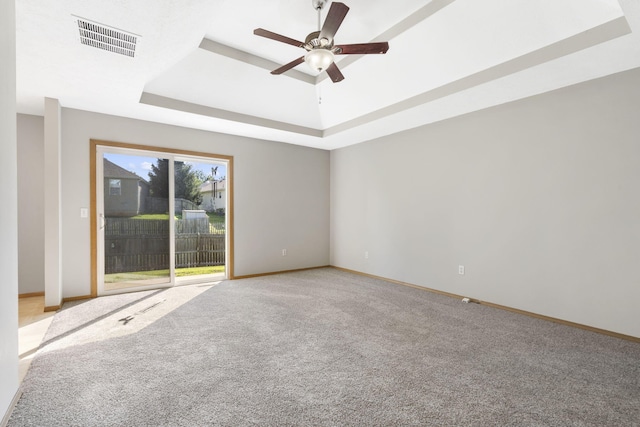 421 W White Ash Rd, Nixa, MO 65714 - spare room featuring a raised ceiling, a ceiling fan, and light carpet