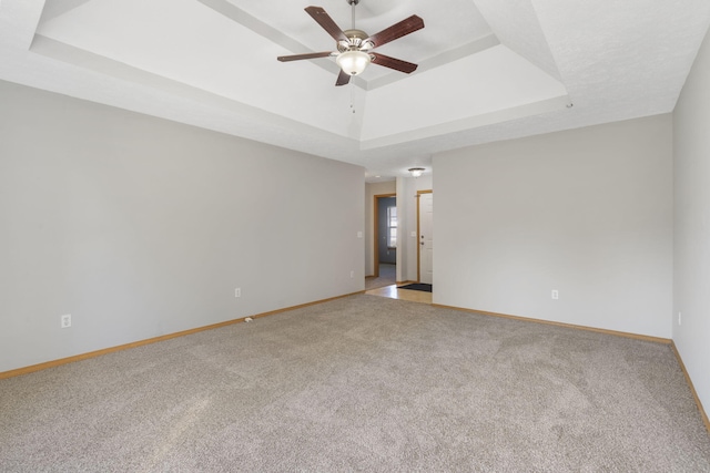 421 W White Ash Rd, Nixa, MO 65714 - unfurnished room featuring a tray ceiling, ceiling fan, and light carpet