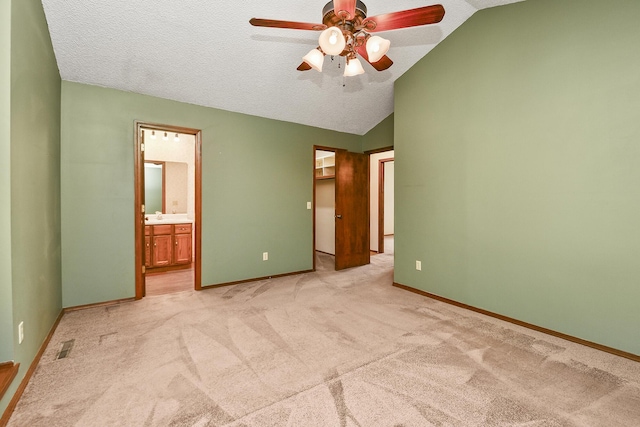 3642 N Olive Ct, Springfield, MO 65803 - unfurnished bedroom featuring vaulted ceiling, light colored carpet, a spacious closet, connected bathroom, and ceiling fan