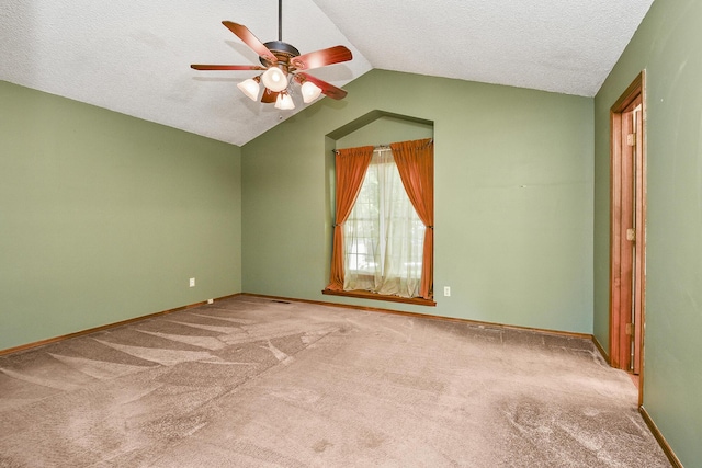 3642 N Olive Ct, Springfield, MO 65803 - empty room featuring a ceiling fan, vaulted ceiling, carpet, and a textured ceiling