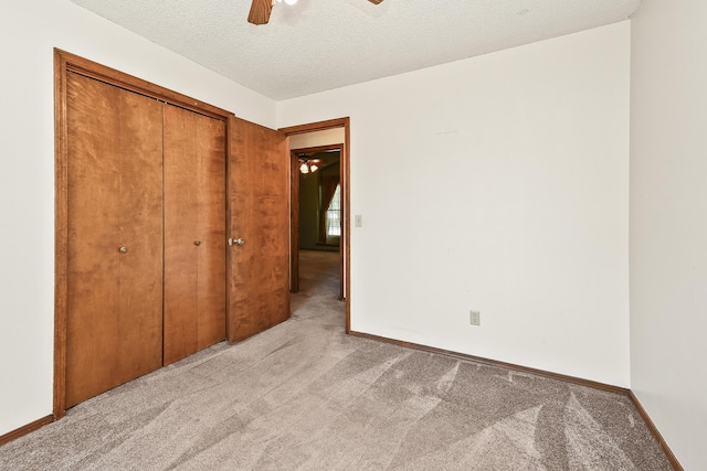 3642 N Olive Ct, Springfield, MO 65803 - unfurnished bedroom with light carpet, a textured ceiling, a closet, and a ceiling fan