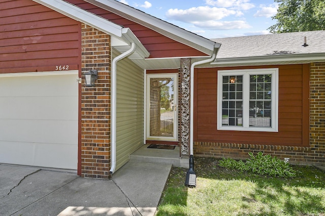 3642 N Olive Ct, Springfield, MO 65803 - doorway to property featuring brick siding, an attached garage, and a shingled roof