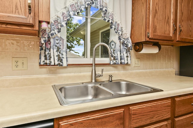 3642 N Olive Ct, Springfield, MO 65803 - kitchen with light countertops, brown cabinetry, and backsplash