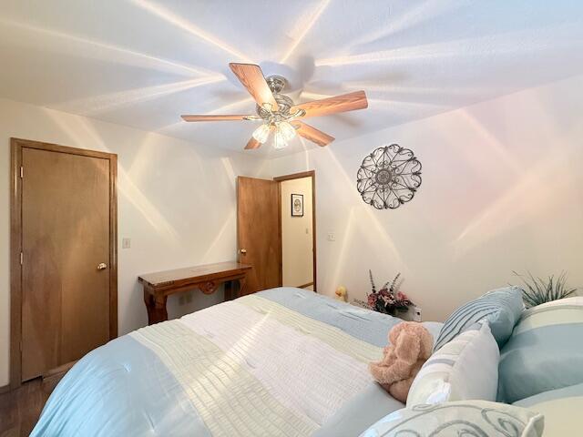 3086 S Suburban Ave, Springfield, MO 65807 - bedroom with ceiling fan and dark wood-type flooring