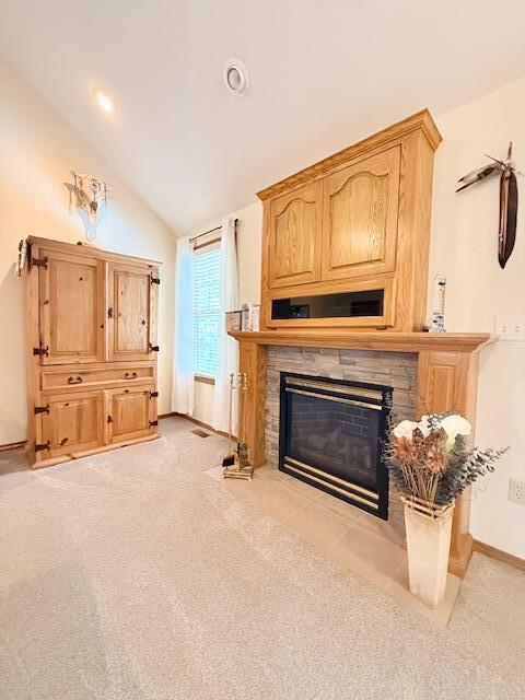 3086 S Suburban Ave, Springfield, MO 65807 - living area with a stone fireplace, vaulted ceiling, light carpet, and recessed lighting
