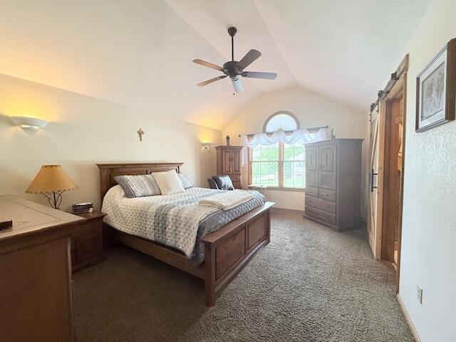 3086 S Suburban Ave, Springfield, MO 65807 - bedroom featuring vaulted ceiling, carpet, a ceiling fan, and a barn door