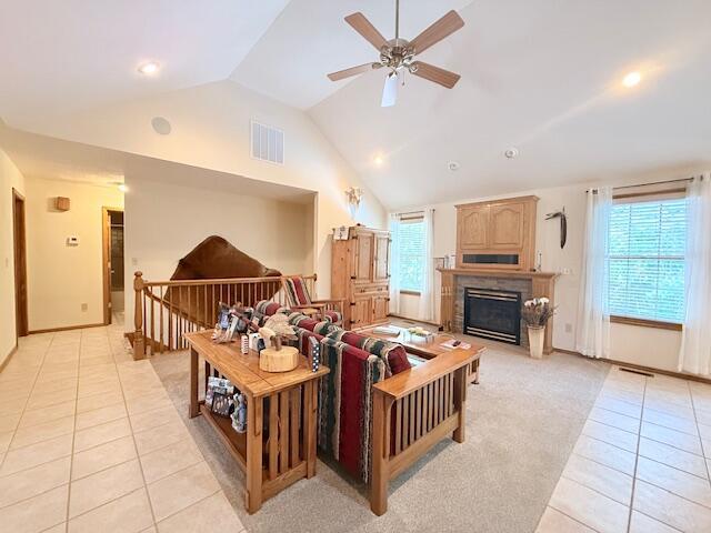 3086 S Suburban Ave, Springfield, MO 65807 - living area featuring light tile patterned floors, vaulted ceiling, a ceiling fan, a glass covered fireplace, and recessed lighting