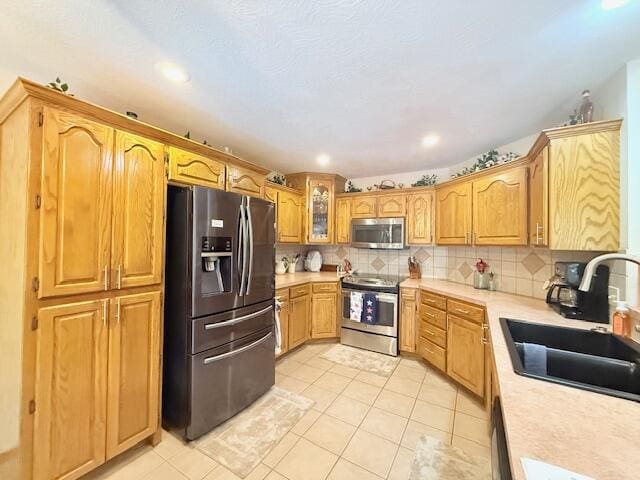 3086 S Suburban Ave, Springfield, MO 65807 - kitchen featuring appliances with stainless steel finishes, light countertops, tasteful backsplash, light tile patterned flooring, and recessed lighting