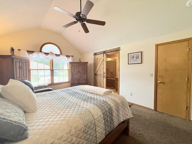 3086 S Suburban Ave, Springfield, MO 65807 - bedroom featuring vaulted ceiling, carpet floors, a barn door, ceiling fan, and ensuite bath