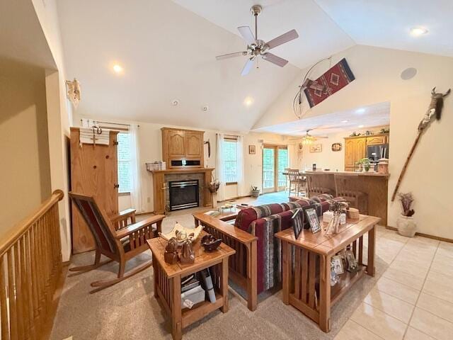 3086 S Suburban Ave, Springfield, MO 65807 - living area with ceiling fan, vaulted ceiling, healthy amount of natural light, a glass covered fireplace, and light tile patterned floors