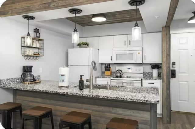 200 Golfview Dr Unit D5, Branson, MO 65616 - kitchen featuring white appliances, white cabinets, a kitchen bar, dark wood finished floors, and light stone counters