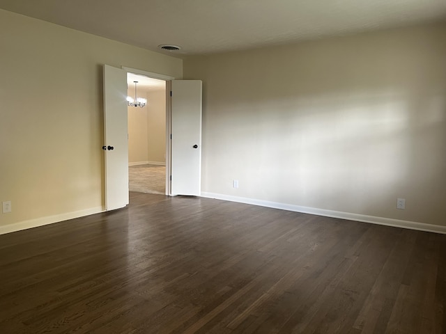 1846 S Nettleton Ave, Springfield, MO 65807 - spare room featuring dark wood finished floors and a chandelier