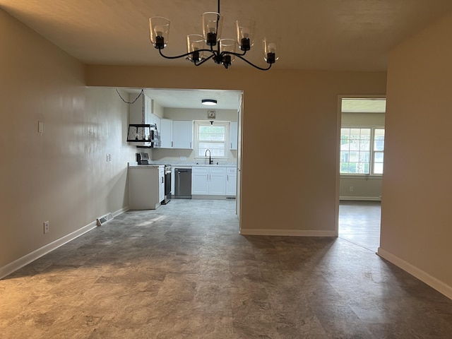 1846 S Nettleton Ave, Springfield, MO 65807 - unfurnished dining area featuring a chandelier and healthy amount of natural light