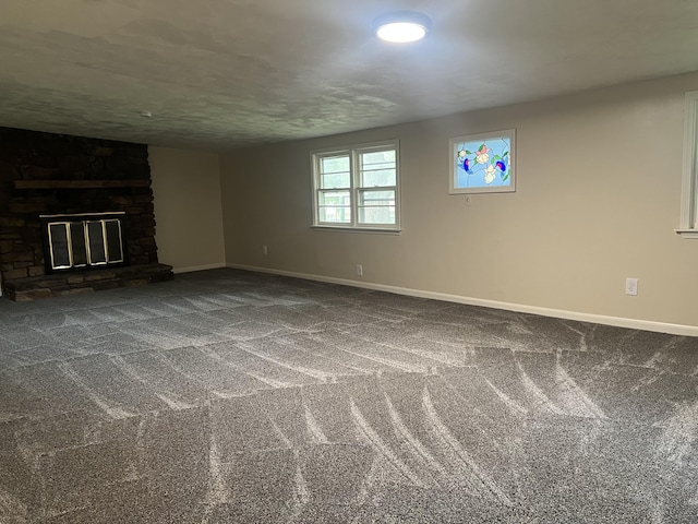 1846 S Nettleton Ave, Springfield, MO 65807 - unfurnished living room featuring carpet and a stone fireplace
