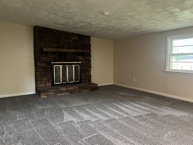 1846 S Nettleton Ave, Springfield, MO 65807 - unfurnished living room featuring a textured ceiling, carpet floors, and a fireplace