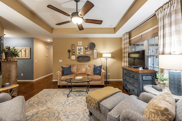 1021 W Whiteside St, Springfield, MO 65807 - living room with dark wood-style flooring, a ceiling fan, and a raised ceiling