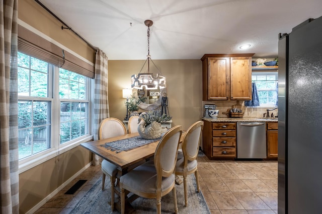 1021 W Whiteside St, Springfield, MO 65807 - dining area featuring a chandelier and baseboards