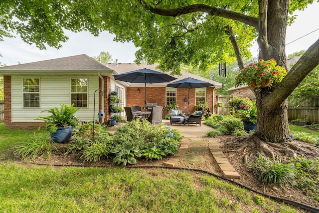 1021 W Whiteside St, Springfield, MO 65807 - rear view of property featuring a patio area, brick siding, and a shingled roof