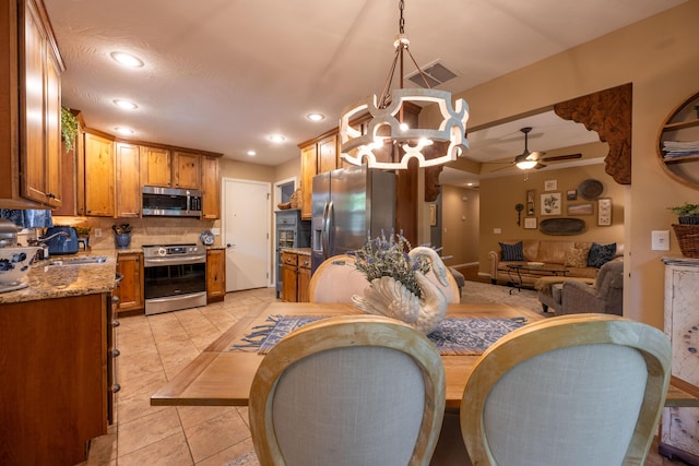 1021 W Whiteside St, Springfield, MO 65807 - dining room featuring a ceiling fan, a chandelier, recessed lighting, and light tile patterned floors