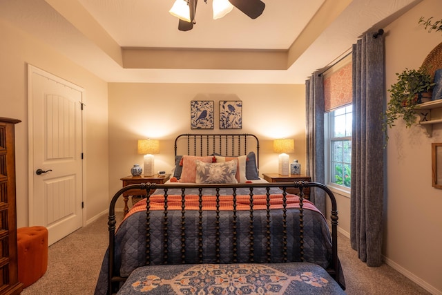 1021 W Whiteside St, Springfield, MO 65807 - carpeted bedroom featuring a tray ceiling and ceiling fan